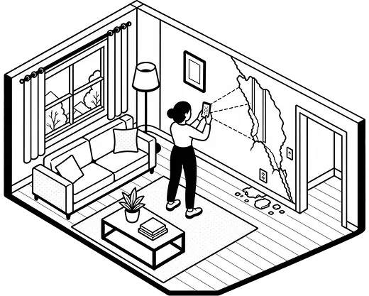 A policyholder photographing a damaged room with a phone